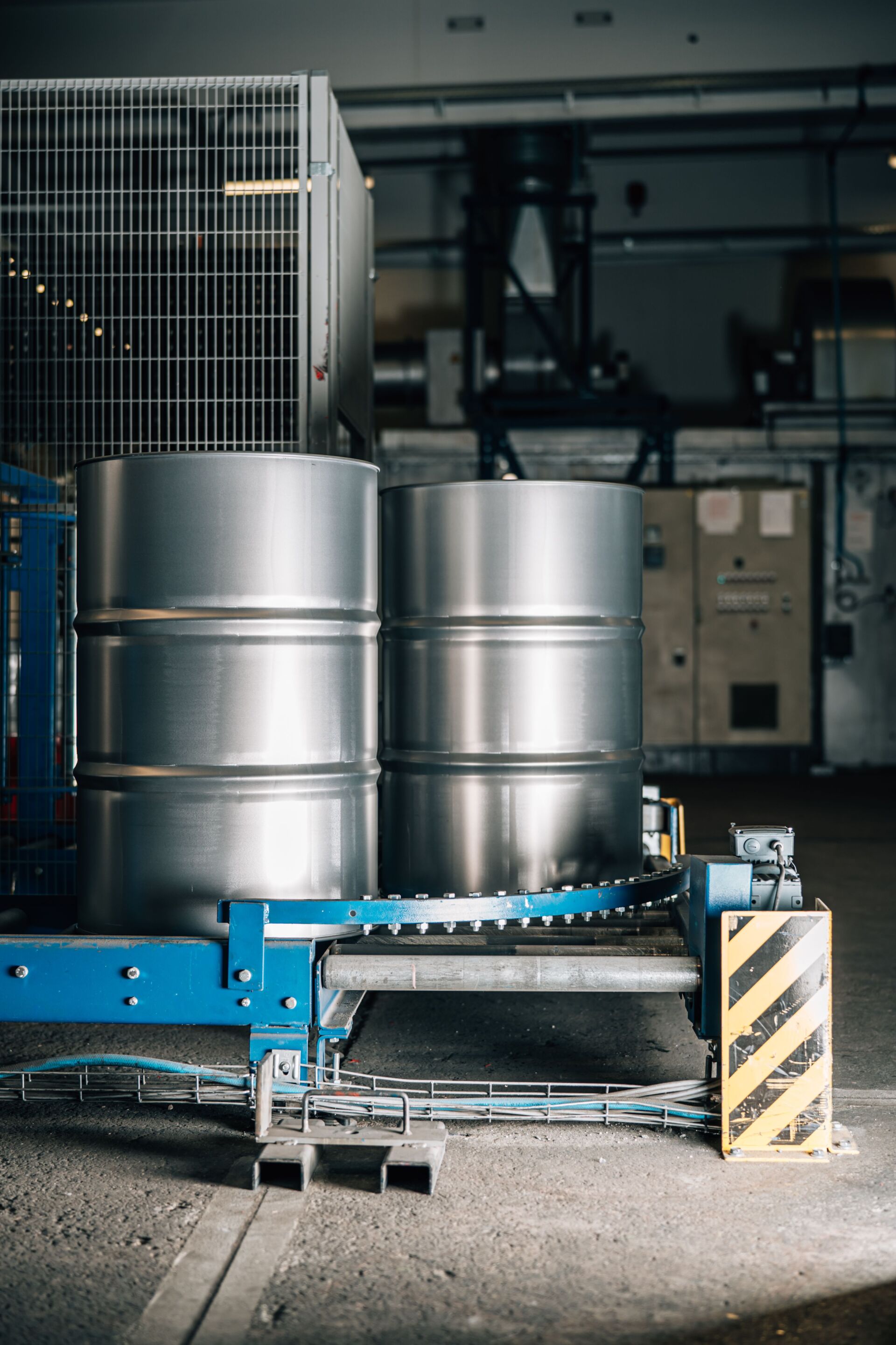 two silver industrial barrels in chemical factory