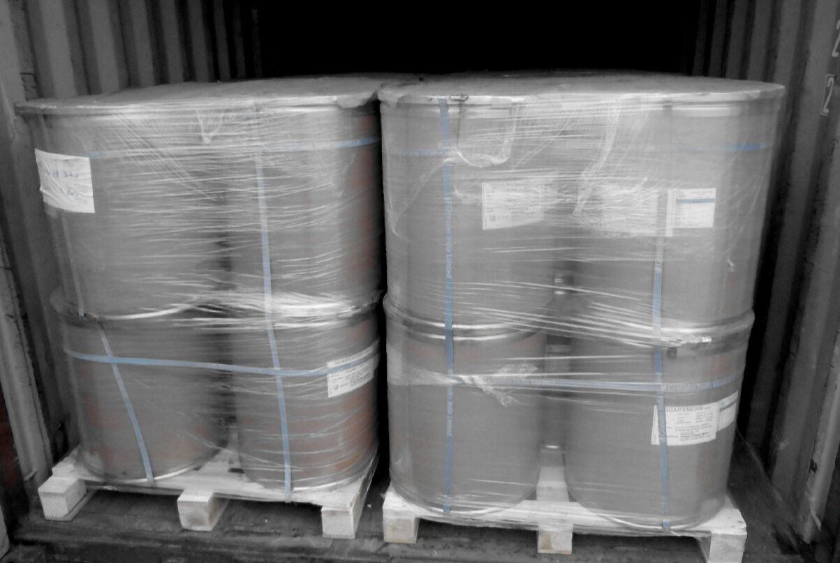 Barrels of chemicals wrapped on a pallet in a truck, ready for delivery