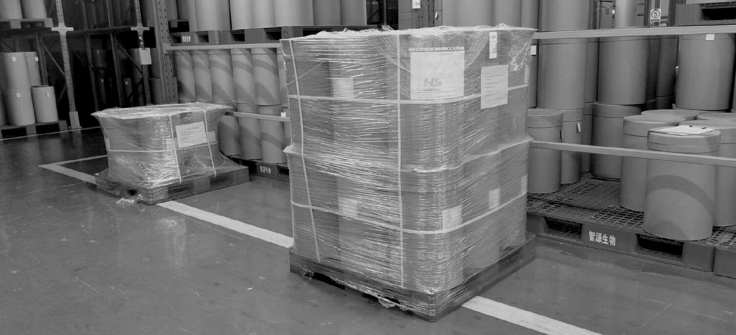 Barrels of chemicals wrapped and on a pallet ready for delivery